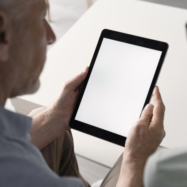 close-up-senior-man-holding-tablet