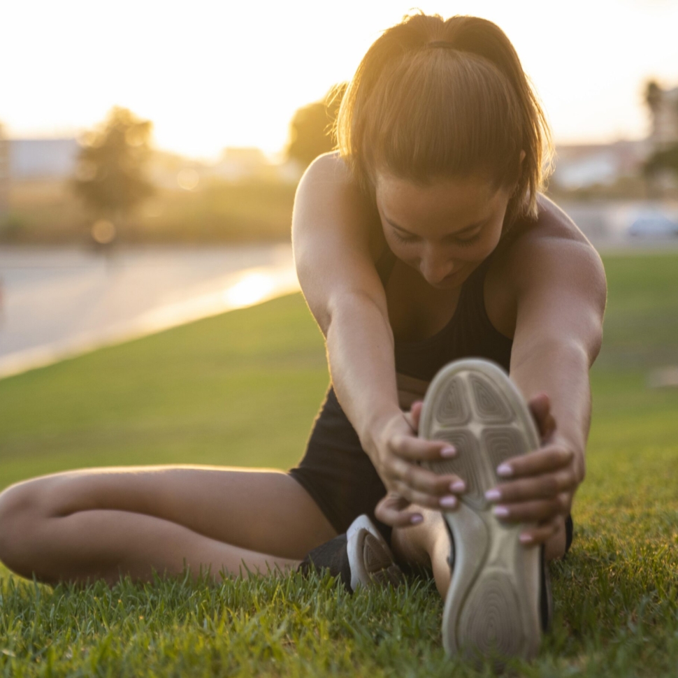 full-shot-woman-stretching-her-leg
