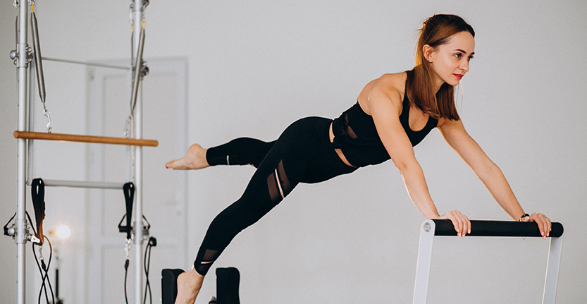 Woman doing pilates on a reformer